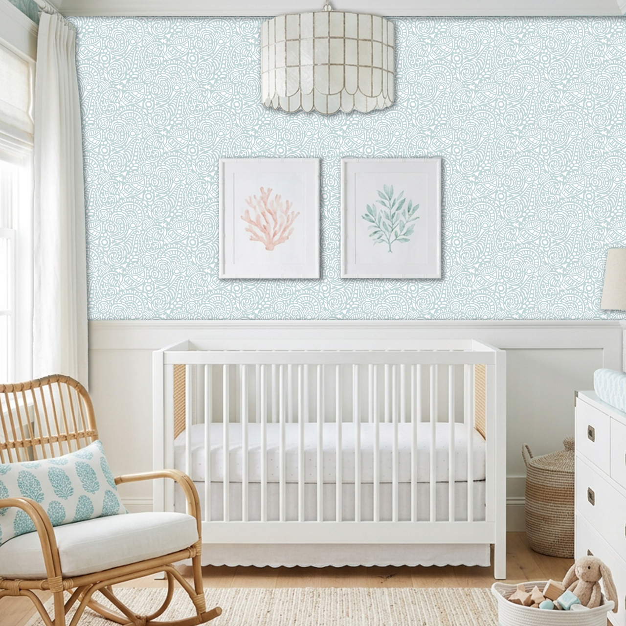 Abstract Seashells wall stencil applied behind a white crib and natural light highlighting the bluish green and white painted stencil on the wall.