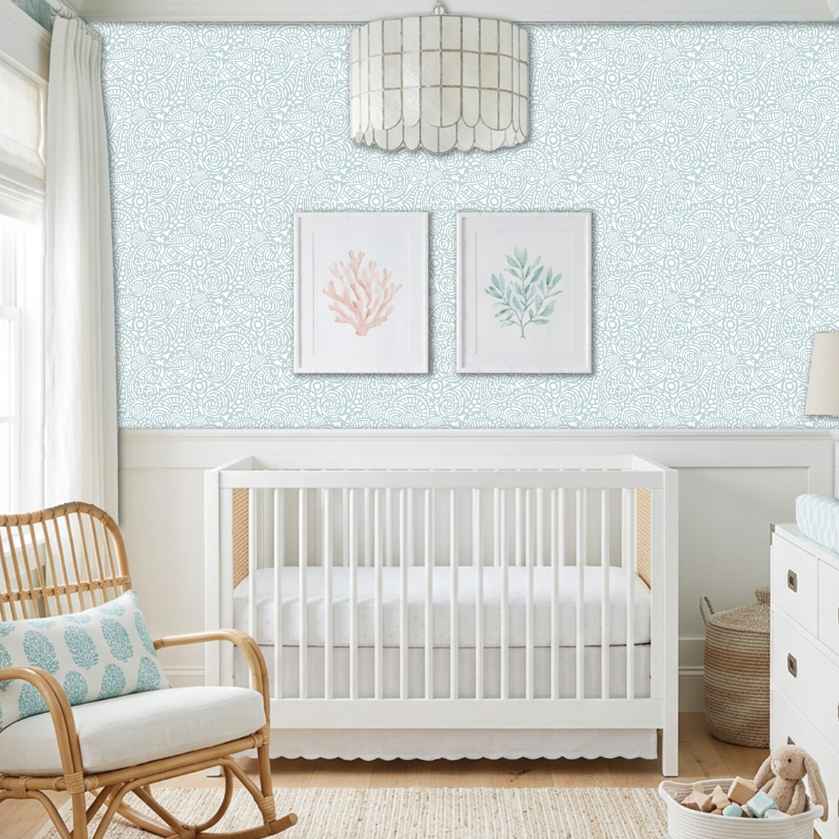 Abstract Seashells wall stencil applied behind a white crib and natural light highlighting the bluish green and white painted stencil on the wall.