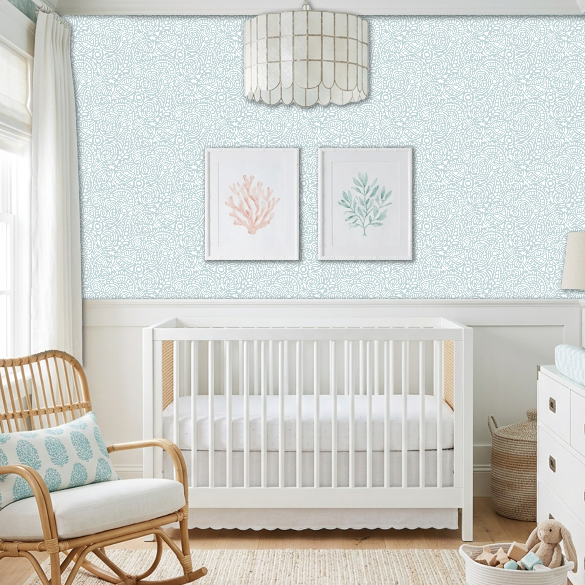 Abstract Seashells wall stencil applied behind a white crib and natural light highlighting the bluish green and white painted stencil on the wall.