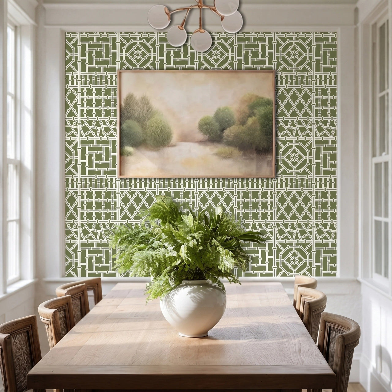 Bamboo wall stencil in a dining room, styled with a framed landscape painting and a green plant, and natural light highlighting the green and white painted stencil on the wall.