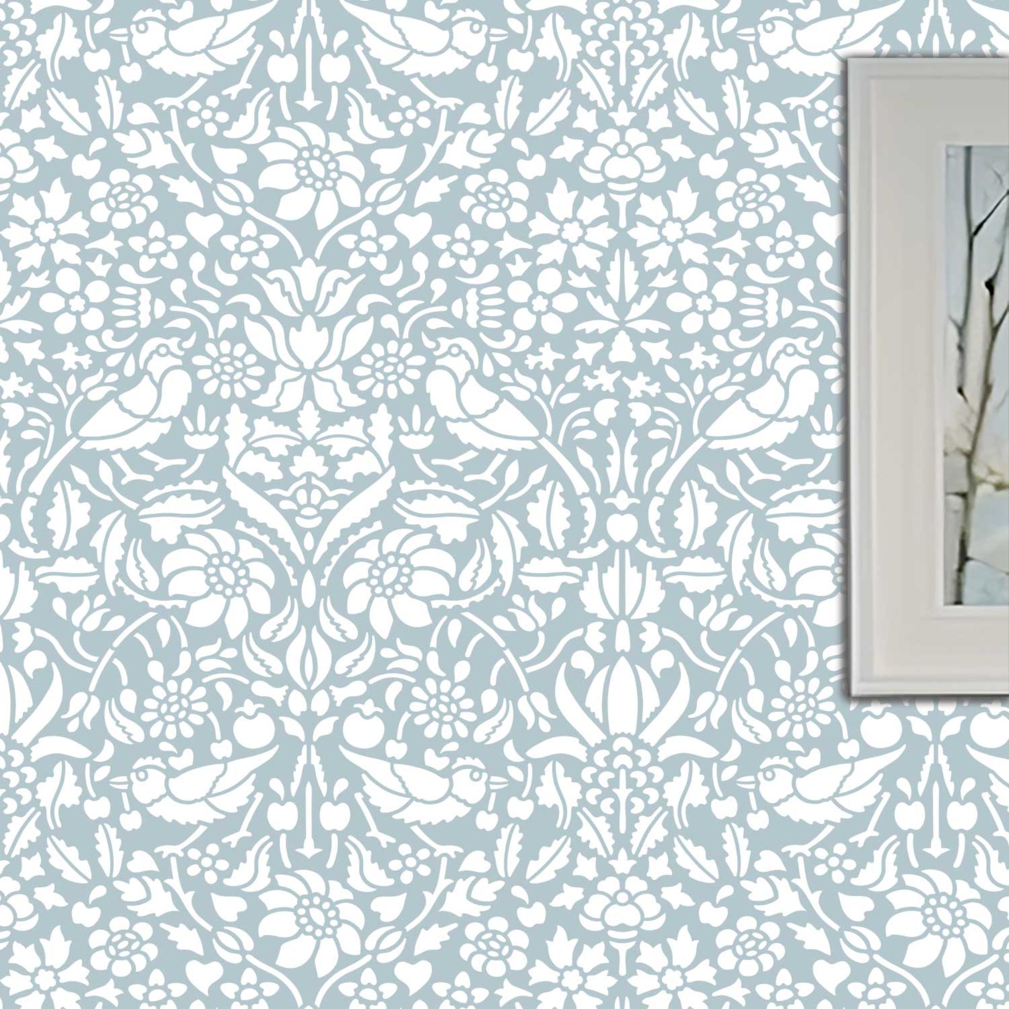 Birds and berries wall stencil shown in blue and white with birds and foliage in repeat motifs, ideal for DIY wall painting and interior decor.
