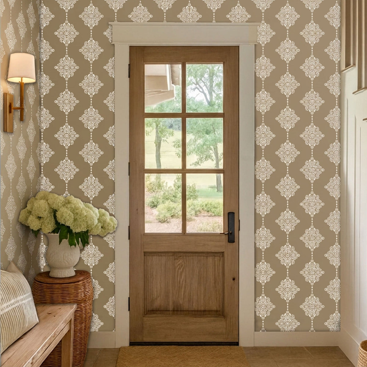 Wooden door entryway with beige hallway with a repeating white damask block print floral wall stencil pattern.