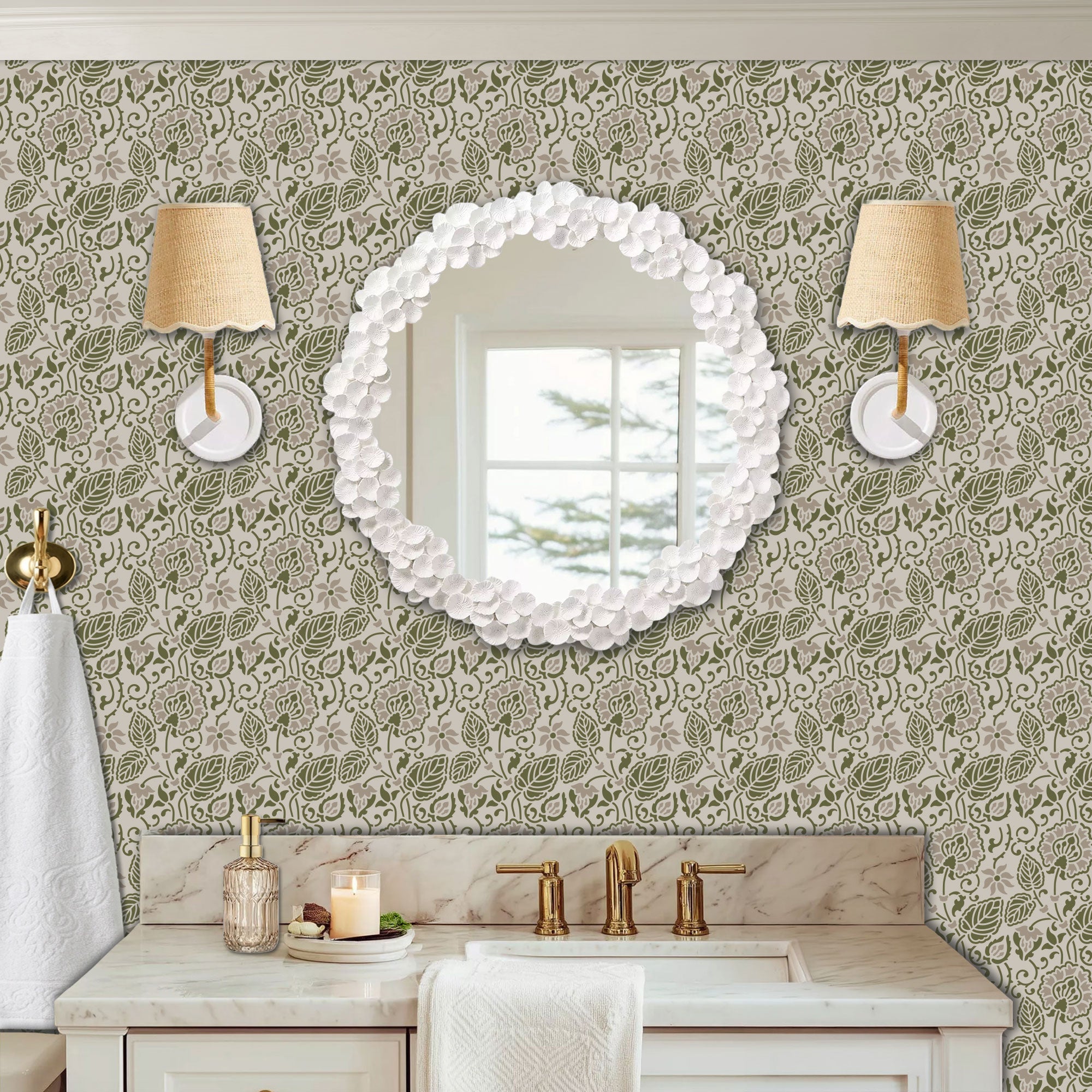 Dandelion wall stencil in a powder room with a round wall mirror, with wall sconces, and a marble sink with brass fixtures, with natural light highlighting the olive green and soft taupe painted stencil on the wall.