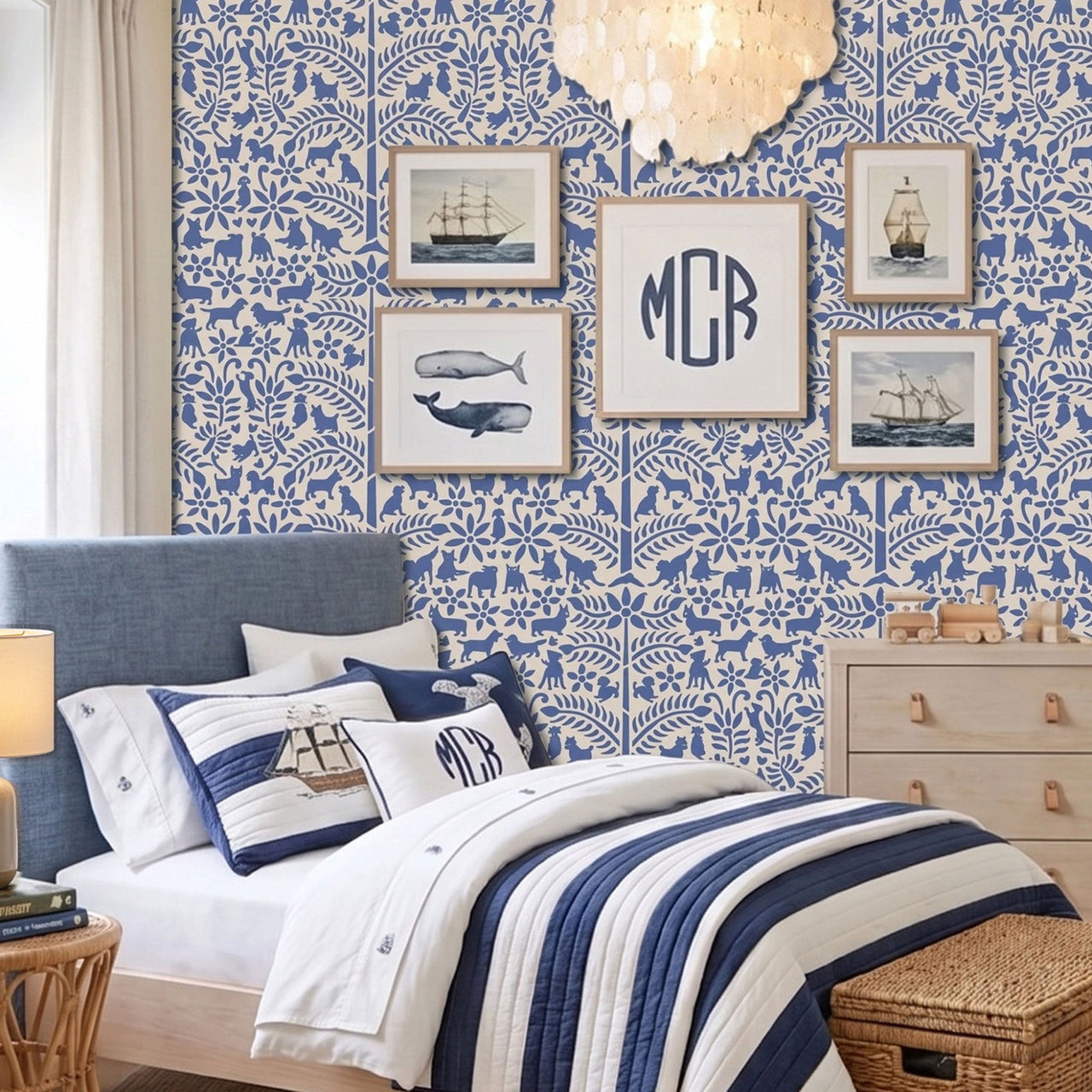 Dogs in the garden wall stencil applied in a children's bedroom featuring a bed with navy and white striped bedding, framed prints, a wood dresser, and a chandelier, and natural light highlighting the dark blue and beige painted stencil on the wall.