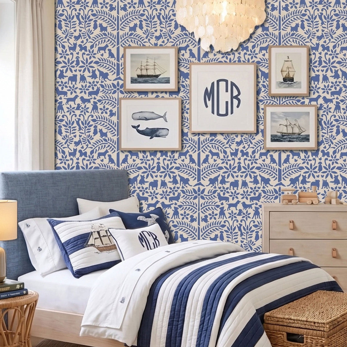 Dogs in the garden wall stencil applied in a children's bedroom featuring a bed with navy and white striped bedding, framed prints, a wood dresser, and a chandelier, and natural light highlighting the dark blue and beige painted stencil on the wall.