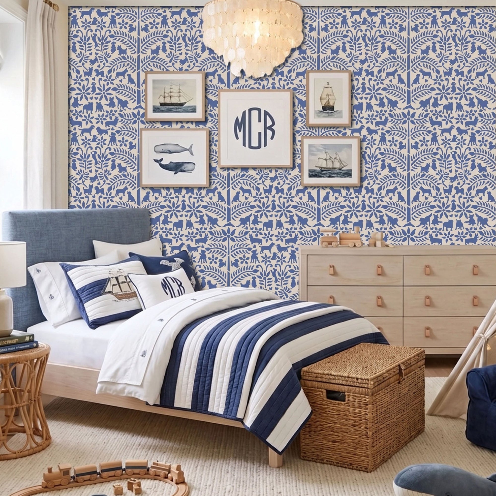 Dogs in the garden wall stencil applied in a children's bedroom featuring a bed with navy and white striped bedding, framed prints, a wood dresser, and a chandelier, and natural light highlighting the dark blue and beige painted stencil on the wall.