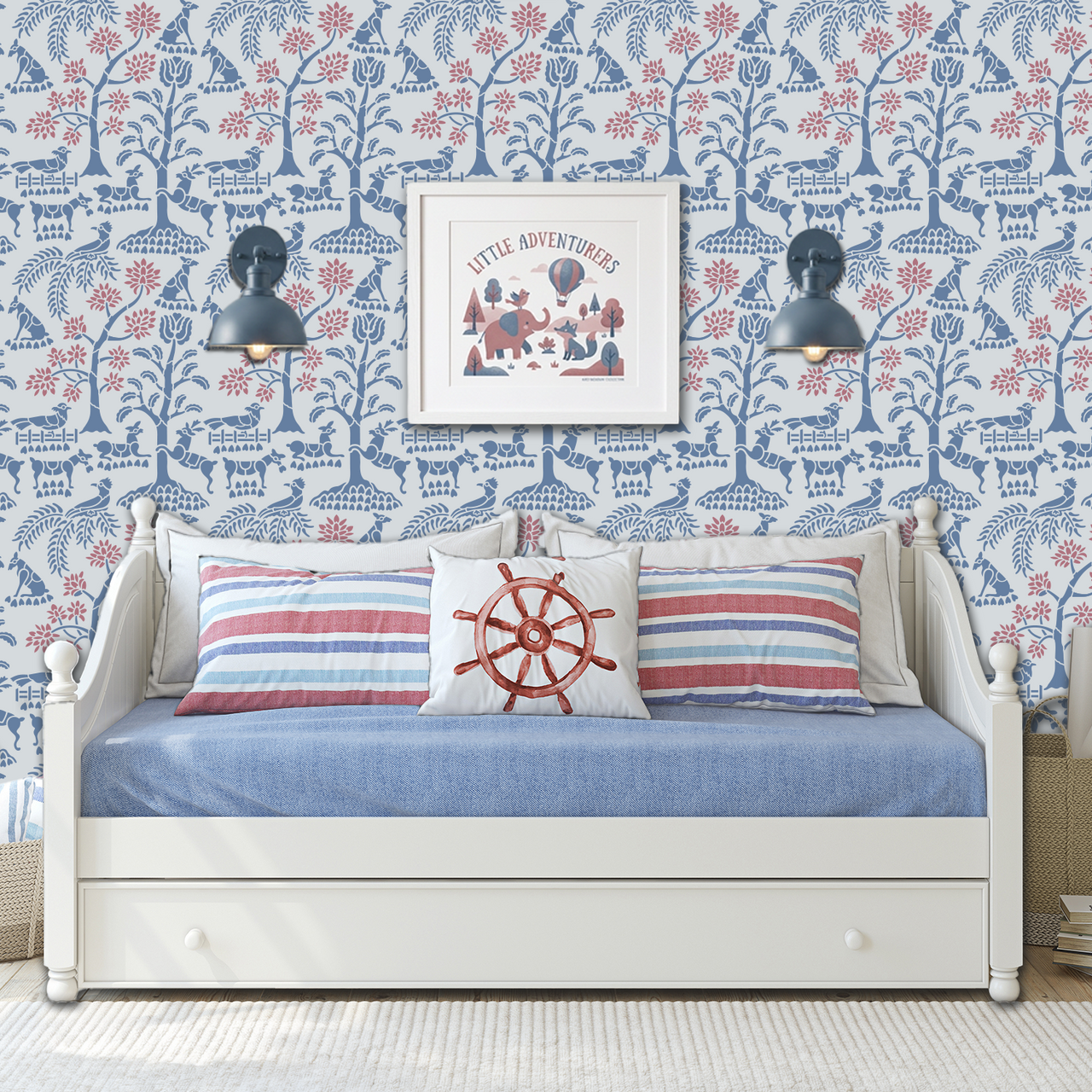 Enchanted forest wall stencil applied in a styled child's bedroom with a dark blue wall sconces mounted on it, a white day bed and framed artwork visible, and the wall scone in on and highlighting the blue and pink painted wall stencil on the wall.