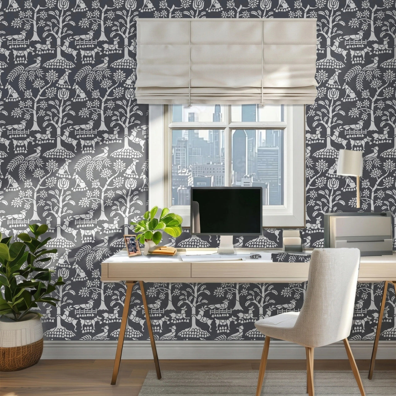 Enchanted forest wall stencil  featured in an office with a window and a beige roman shade, a desk with a computer monitor, plants, a chair, and natural light highlighting the charcoal and light grey painted stencil on the wall.