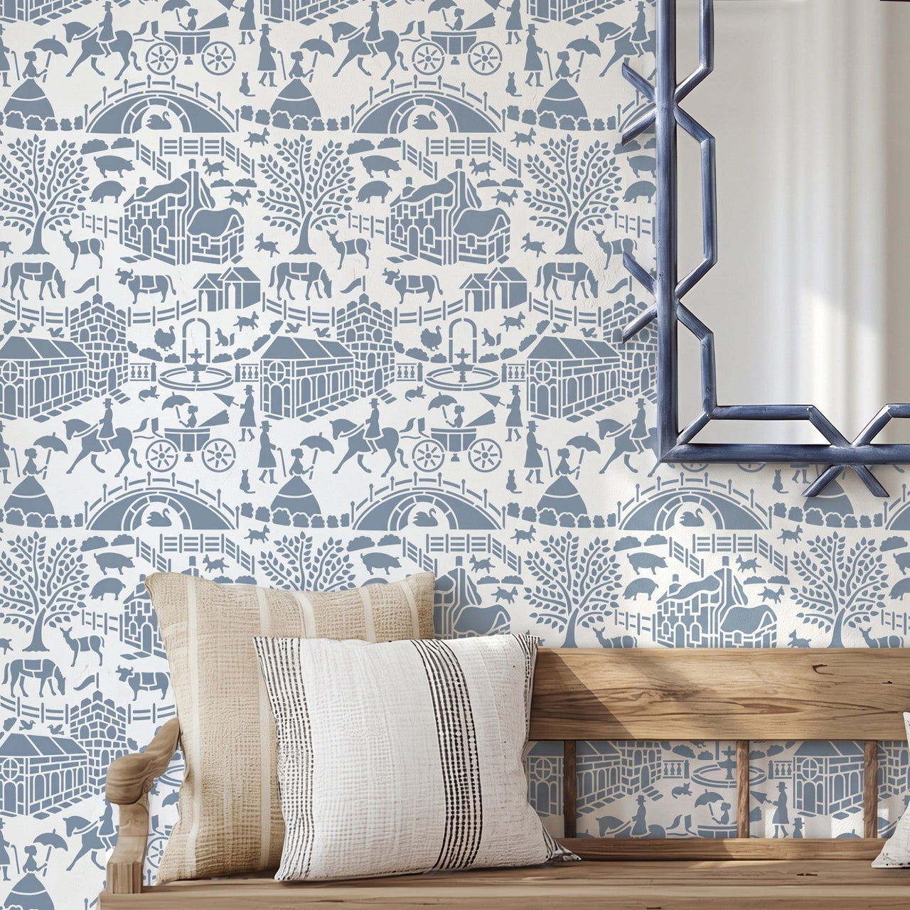 English storybook wall stencil applied in a hallway with a bench, pillows and a mirror, and natural light highlighting the blue and white painted stencil on the wall.