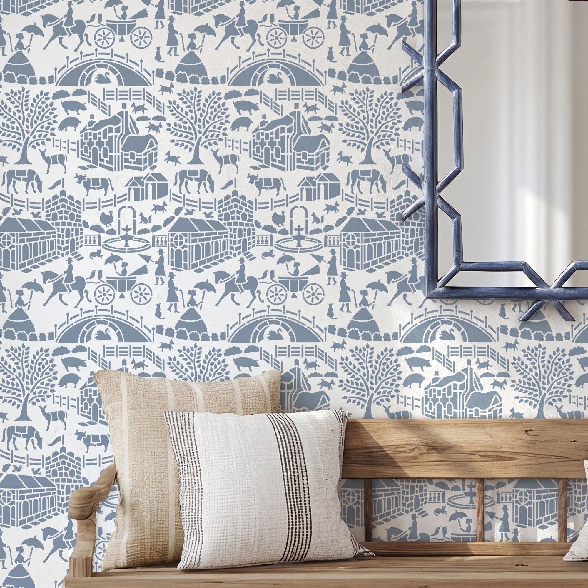 English storybook wall stencil applied in a hallway with a bench, pillows and a mirror, and natural light highlighting the blue and white painted stencil on the wall.