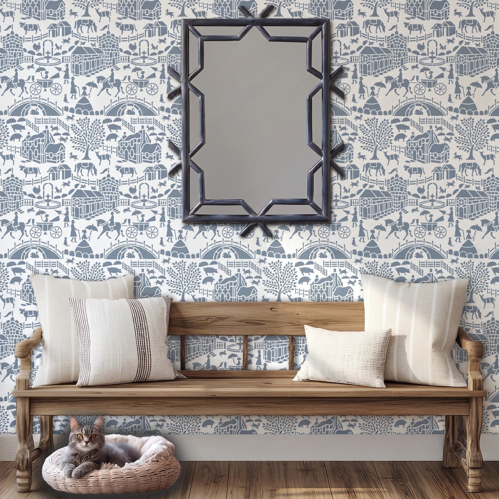 English storybook wall stencil applied in a hallway with a bench, pillows and a mirror, a cat lying in it's bed and natural light highlighting the blue and white painted stencil on the wall.