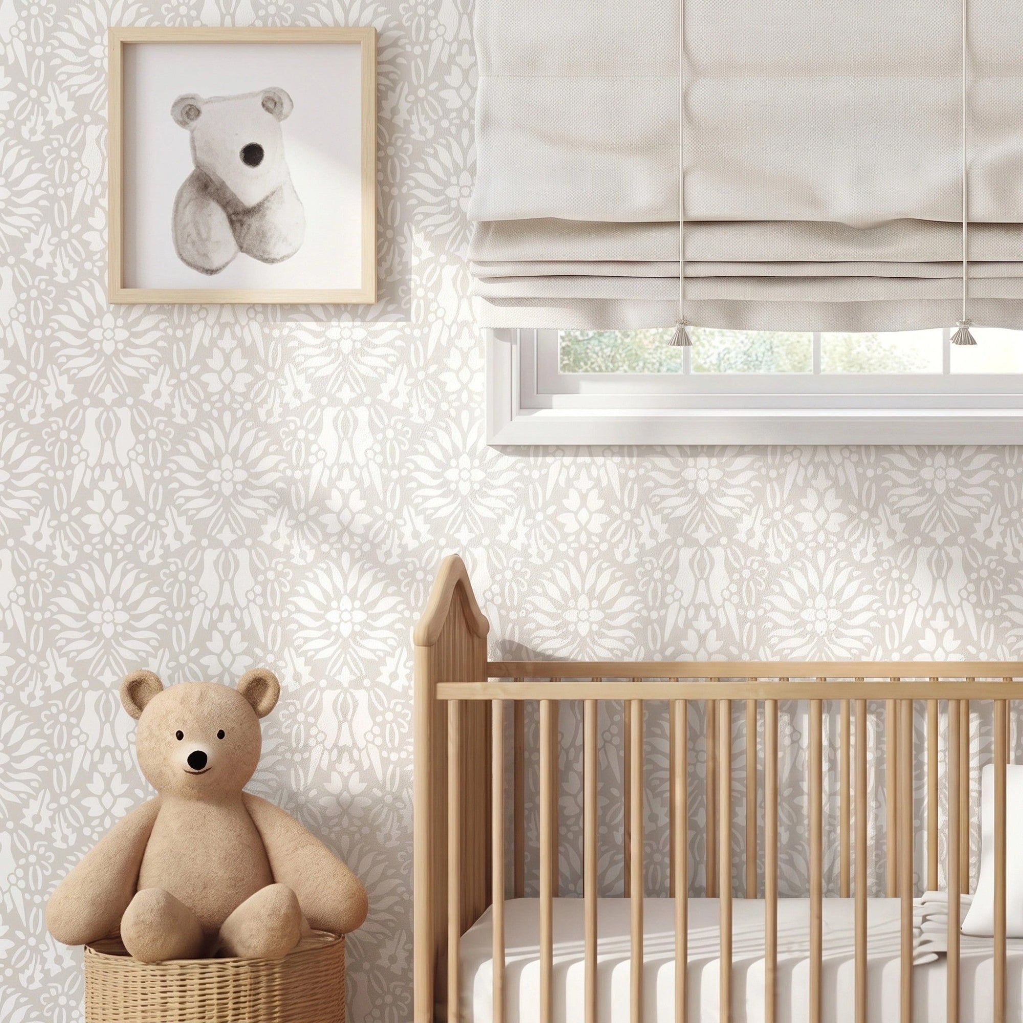 Morning Dove applied in a nursery room scene with a wood baby crib with white bedding, a cream Roman shade, two teddy bears, and framed bear illustrations on the wall, and natural light highlighting the beige and white painted stencil on the wall.