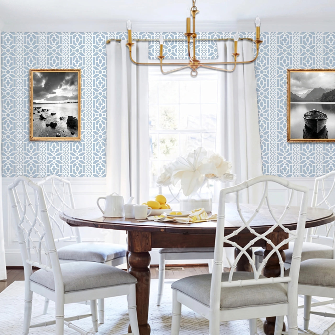 Moroccan Lattice wall stencil applied in a dining room featuring a round wooden table with white chairs, a gold chandelier, a window with curtains, and natural light highlighting the light blue and white geometric stencil on the wall.
