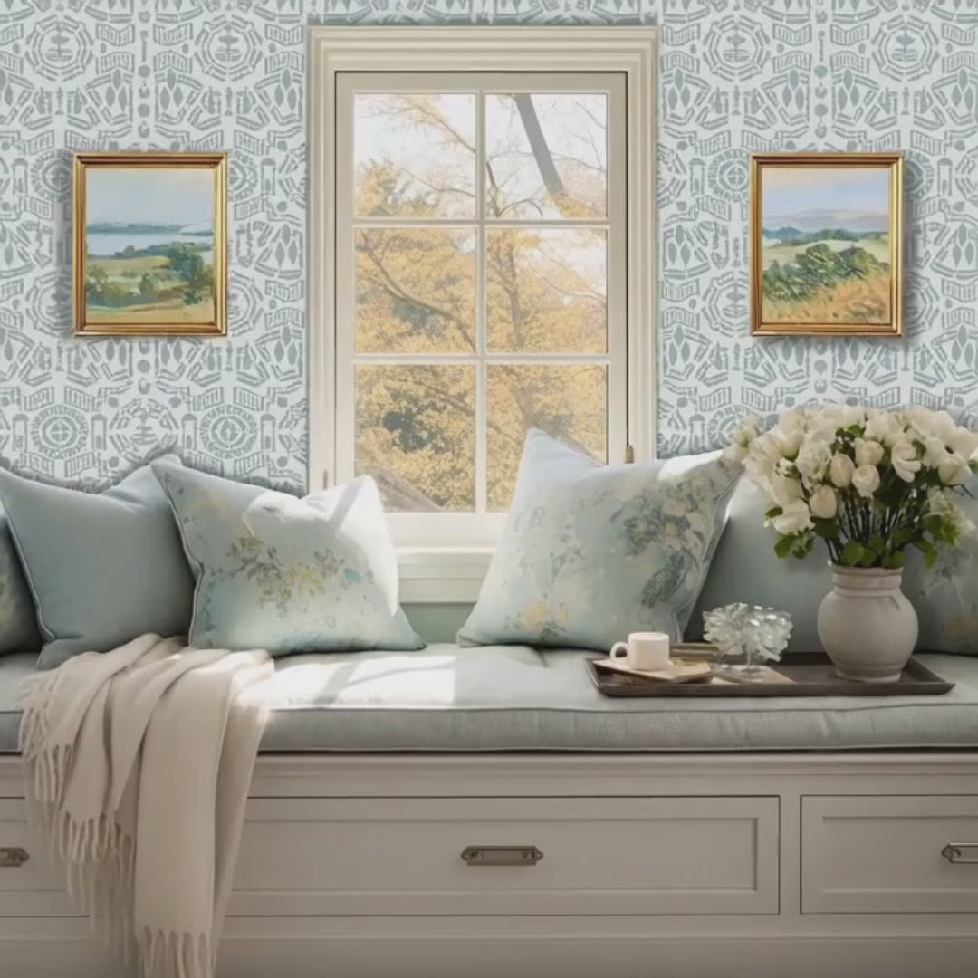 Topiary Garden wall stencil. Woman sits in window seat with a book. Cat jumps up on the cushion and woman reaches for a cup of coffee video.