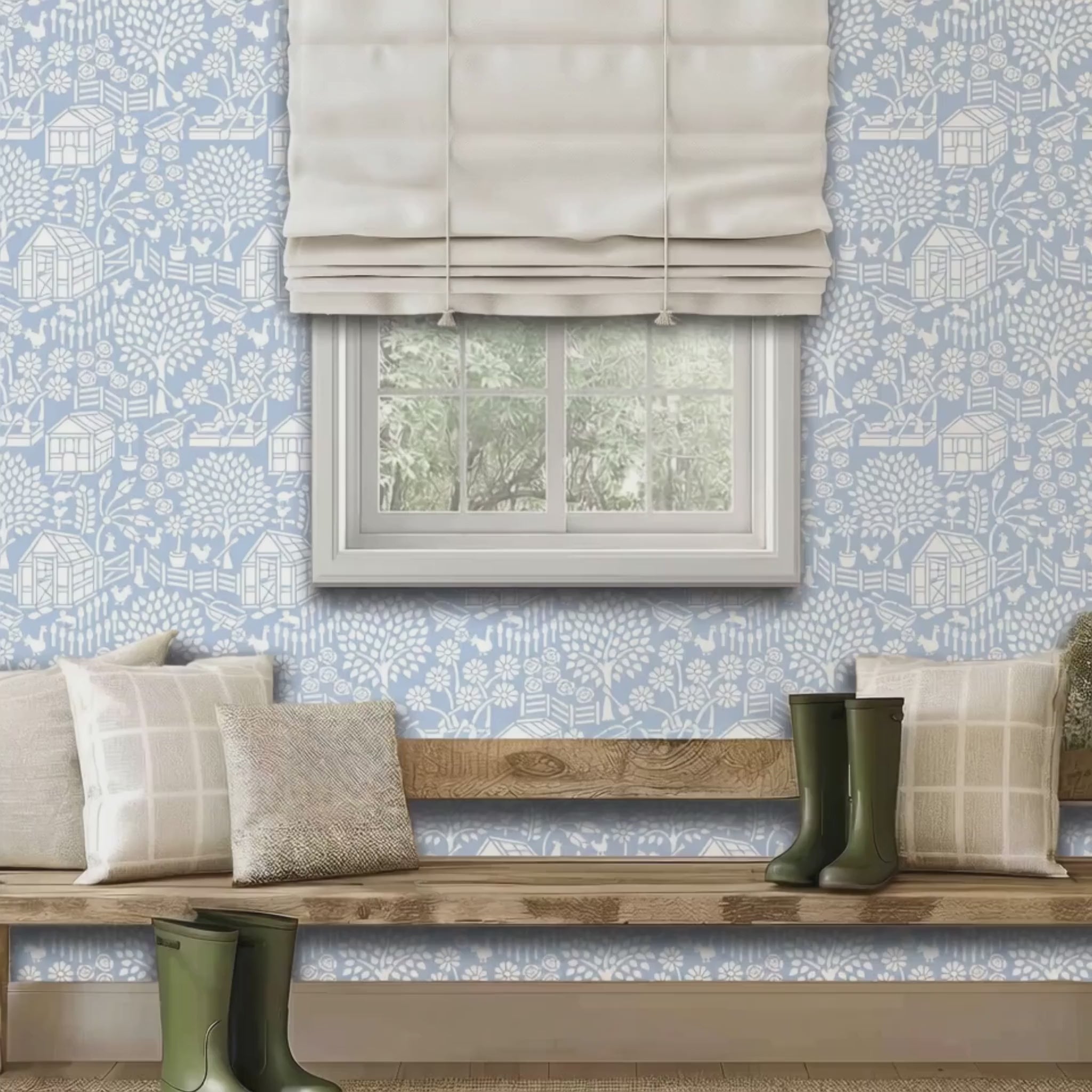 Video of floral garden wall stencil applied in a bright room with a wooden bench, wellington boots, cushions and a window, and natural light highlighting the light blue and white painted stencil on the wall. A man enters the room, sits on the bench and pets his dog.