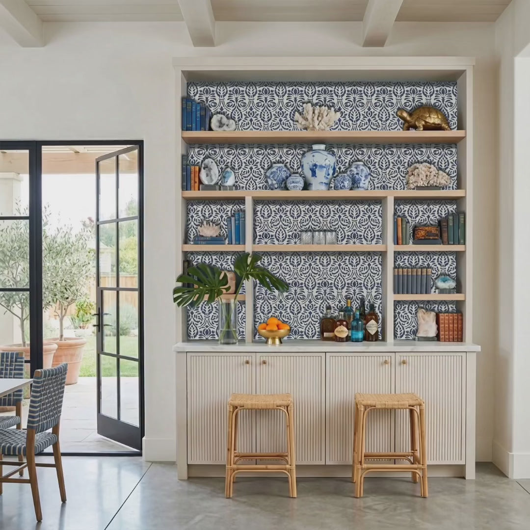 Spear thistle wall stencil painted behind built in bar. Man, woman and dog enter the room from the garden and pull out the bar stools video.