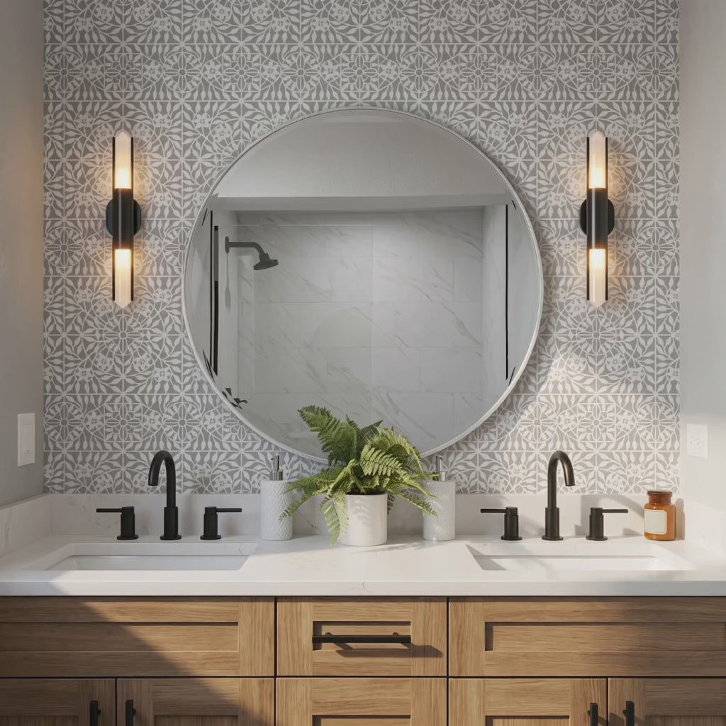 Botanical Tile wall stencil painted on the walls in a bathroom. Woman enters the bathroom holding some towels and places them inside the center drawer in the bathroom vanity.