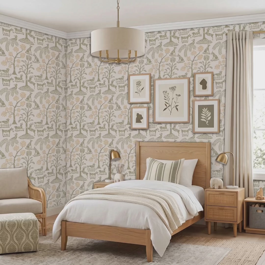 Video of enchanted forest wall stencil in a bedroom with a bed with a headboard , framed  prints hang on the wall, with a hanging drum lamp and bedside tables with lamps, and natural light highlighting the olive green and peach painted stencil on the wall. Young boy is playing with a puppy.